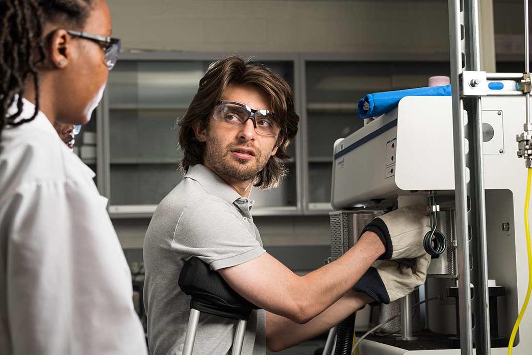 Two researchers looking an an optical instrument array